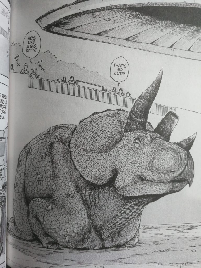 A triceratops sits in the "cat loaf" position with its arms and legs folded underneath its body